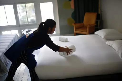 In this Thursday, Sept. 20, 2018 photo, a cleaning lady works in an apartment located on Airbnb in Paris.  Airbnb hosts are facing an onslaught of frustrations born of renting out their properties to short-term guests. Certain guests have proven disrespectful of hosts’ homes, with some squatting illegally — and getting away with it — and others trashing properties with Silly String, feces and more.  (AP Photo/Thibault Camus, file)