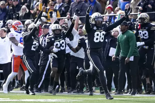 Vanderbilt defensive end Michael Owusu (88) celebrates after Jaylen Mahoney (23) intercepted a pass against Florida in the second half of an NCAA college football game Saturday, Nov. 19, 2022, in Nashville, Tenn. Vanderbilt won 31-24. (AP Photo/Mark Humphrey)