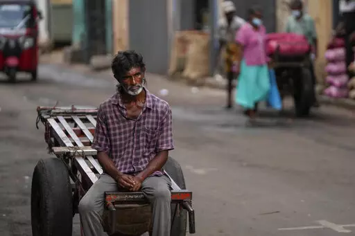 A daily wage laborer waits for work at a wholesale market in Colombo, Sri Lanka, Sunday, June 26, 2022. Sri Lankans have endured months of shortages of food, fuel and other necessities due to the country's dwindling foreign exchange reserves and mounting debt, worsened by the pandemic and other longer term troubles. Some 1.6 billion people in 94 countries face at least one dimension of the crisis in food, energy and financial systems, according to a report last month by the Global Crisis Respons