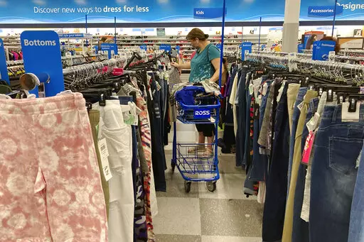 A consumer shops as she wears a mask at a retail store in Morton Grove, Ill., Wednesday, July 21, 2021. With fewer pandemic-related restrictions this year, the option to do more can result in the urge to spend.   (AP Photo/Nam Y. Huh)