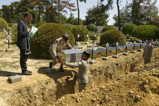 French army officers place the remains of 17 missing French soldiers who fought in the World War I Battle of Gallipoli, in Canakkale, Turkey, Sunday, April 24, 2022. The remains were on Sunday handed over to French military officials and put to rest alongside other fallen comrades, more than a hundred years after their deaths. The remains were found during restoration work on a castle and surrounding areas on Turkey's northwestern Canakkale peninsula, where Allied forces fought against Ottoman T