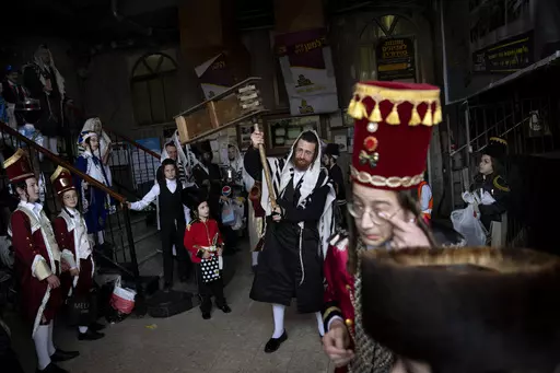 Jewish ultra-Orthodox men and children, some wearing costumes, celebrate the festival of Purim at a synagogue in Bnei Brak, Israel, March 17, 2022. Purim celebrates the biblical story of how a plot to exterminate Jews in Persia was thwarted, and thus is embraced as an affirmation of Jewish survival throughout history. For many Jews, it will have extra significance in 2024 during a war in Gaza triggered by the Oct. 7, 2023, attacks on Israel in which Hamas killed 1,200 people and took about 250 o