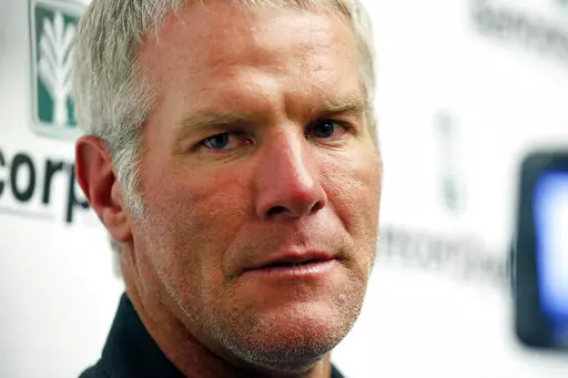 Former NFL football quarterback Brett Favre speaks with reporters prior to his induction to the Mississippi Hall of Fame in Jackson, Miss., on Aug. 1, 2015. Favre is asking to be removed from a civil lawsuit in Mississippi that seeks to recover millions of dollars in misspent welfare money that was intended to help some of the poorest people in the U.S. (AP Photo/Rogelio V. Solis, File)