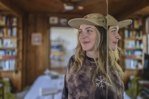 Displaced tenant Heather McAlpine who lost her Altadena studio in the Eaton fire, stands inside her temporarily home in Los Angeles on Monday, Feb. 17, 2025. (AP Photo/Damian Dovarganes)