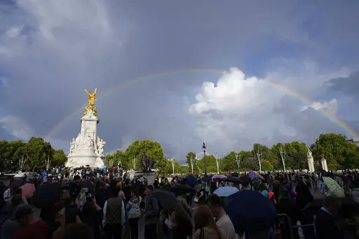 People gather outside Buckingham Palace in London, Thursday, Sept. 8, 2022. Buckingham Palace says Queen Elizabeth II has been placed under medical supervision because doctors are "concerned for Her Majesty's health." Members of the royal family traveled to Scotland to be with the 96-year-old monarch. (AP Photo/Frank Augstein)
