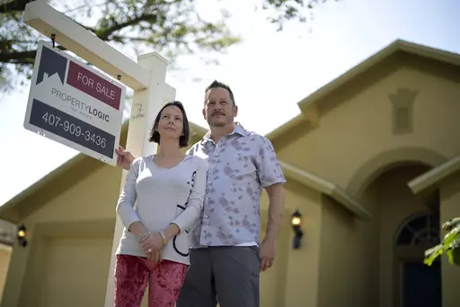 Scott and Sheila Collett stand in front of the home that they recently purchased, Tuesday, Feb. 21, 2023, in Valrico, Fla. Collett negotiated a seller-paid mortgage rate buydown to close the deal on the four-bedroom, two-bathroom house with a pool. (AP Photo/Phelan M. Ebenhack)