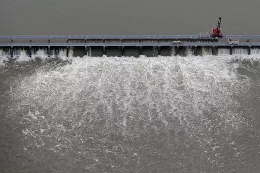Workers open bays of the Bonnet Carre Spillway to divert rising water from the Mississippi River to Lake Pontchartrain, upriver from New Orleans, in Norco, La., May 10, 2019. The U.S. Army Corps of Engineers appealed a federal judge’s ruling Monday, March 20, 2023, that itmust consult with federal fisheries experts before opening the spillway that protects New Orleans from Mississippi River flooding. (AP Photo/Gerald Herbert, File)