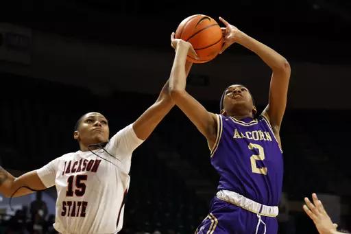 Jackson State guard Angel Jackson (15) blocks a shot-attempt by Alcorn State guard Nakia Cheatham (2) during the first half of an NCAA college basketball game in the championship of the Southwestern Athletic Conference tournament, Saturday, March 16, 2024, in Birmingham, Ala. (AP Photo/ Butch Dill)