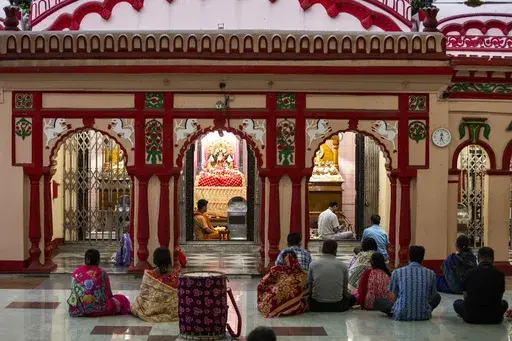 Hindu devotees pray at the Dhakeshwari National Temple in Dhaka, Bangladesh, Sunday, Aug.11, 2024. (AP Photo/Rajib Dhar)