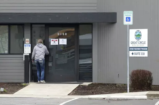 A woman enters the Great Circle drug treatment center in Salem, Ore., on March 8, 2022. Two years ago, Oregonians voted to decriminalize drugs and dedicate hundreds of millions of dollars to treatment services, but the state's first-in-the-nation drug decriminalization has had a rocky start. Secretary of State Shemia Fagan said on Thursday, Jan. 19, 2023, as she released an audit of the program that it's too early to call it a failure. (AP Photo/Andrew Selsky, File)