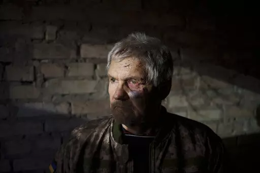 Anatolii Kaharlytskyi, 73, stands inside his house, heavily damaged after a Russian attack in Kyiv, Ukraine, Monday, Jan. 2, 2023. Kaharlytskyi was injured and his daughter in law Iryna died in the attack on Dec. 31, 2022. (AP Photo/Renata Brito)
