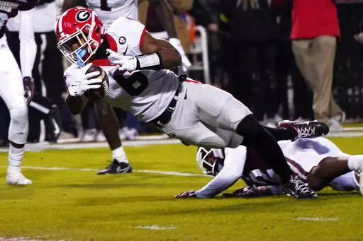 Georgia running back Kenny McIntosh (6) is tackled by a Mississippi State defender as he tries to get into the end zone during the first half of an NCAA college football game in Starkville, Miss., Saturday, Nov. 12, 2022. (AP Photo/Rogelio V. Solis)