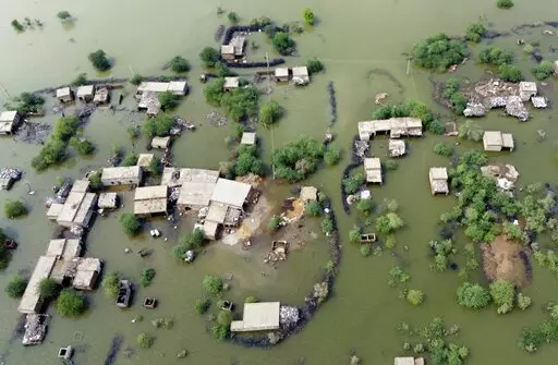 Homes are surrounded by floodwaters in Sohbat Pur city, a district of Pakistan's southwestern Baluchistan province, Aug. 30, 2022. This past year has seen a horrific flood that submerged one-third of Pakistan, one of the three costliest U.S. hurricanes on record, devastating droughts in Europe and China, a drought-triggered famine in Africa and deadly heat waves all over. (AP Photo/Zahid Hussain, File)