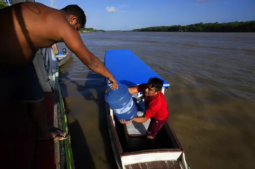 Gallons of water for human consumption are transported on passenger boats to serve communities located on the islands of the Bailique Archipelago in the district of Macapa, state of Amapa, northern Brazil, Saturday, Sept. 10, 2022. The Amazon River discharges one-fifth of all the world’s freshwater that runs off land surface. Despite that force, the seawater pushed back the river that bathes the archipelago for most of the second half of 2021, leaving thousands scrambling for drinking water. (