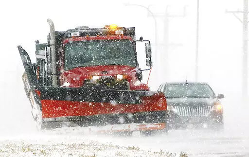 A South Dakota state snow plow clears a shoulder along Highway 50 on the north edge of Yankton, S.D., on Thursday, Dec. 15, 2022, as light snow swept by strong winds reduced visibility to a quarter-mile at times. Yankton is about 200 miles east of the Rosebud Sioux Reservation, which was battered by a mid-December snowstorm that left roads impassable. A 12-year-old asthmatic boy was among six people who died on the reservation during the storm. The tribe says all of the deaths could have been pr