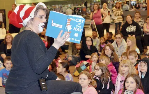 Barb Tack, of the Ashtabula County District Library, reads "Cat in the Hat" during a Dr. Seuss event in Ashtabula Township, Ohio on March 22, 2014. (Warren Dillaway/The Star-Beacon via AP)