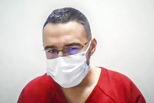 In this image taken from a Zoom screen, Solomon Peña listens as Judge David Murphy orders the defendant to remain behind bars during a court appearance Monday morning. Jan. 23, 2023, in Albuquerque, N.M. Peña, 39, a political newcomer who lost his bid for the New Mexico statehouse and is accused of orchestrating a series of drive-by shootings at the homes of Democratic officials will remain in custody pending trial after the judge agreed Monday that he is a danger to the community. (Roberto E.