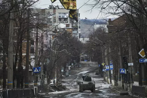 Ukrainian soldiers ride in a Humvee in Bakhmut, Donetsk region, Ukraine, Wednesday, Dec. 21, 2022. (AP Photo/Libkos, File)