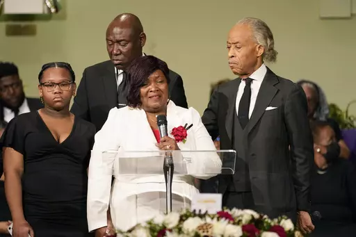 FILE -Bettersten Wade speaks to the attendees of her son Dexter Wade's funeral service in Jackson, Miss. Monday, Nov. 20, 2023. Looking on are the Rev. Al Sharpton, right, who delivered the eulogy, civil rights attorney Ben Crump, background, and one of her son's daughters, Jaselyn Thomas. Bettersten Wade, a woman who sued Mississippi's capital city over the death of her brother has decided to reject a settlement after officials publicly disclosed how much the city would pay his survivors, her a