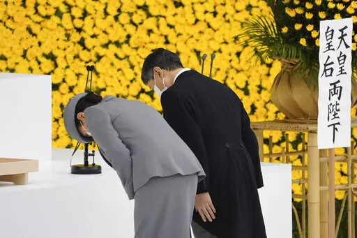 Japan's Emperor Naruhito, right, and Empress Masako bow during a ceremony to mark the 76th anniversary of Japan's surrender in World War II at Budokan hall in Tokyo Sunday, Aug. 15, 2021. (Toru Hanai/Pool Photo via AP)