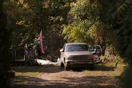 A confederate flag hangs from a porch on a property in Munith, Mich., Oct. 9, 2020, where law enforcement officials said suspects accused in a plot to kidnap Michigan Democratic Gov. Gretchen Whitmer met to train and make plans. Four members of anti-government groups are on trial on federal charges accusing them of plotting to abduct Whitmer in 2020. (Nicole Hester/Ann Arbor News via AP, File)