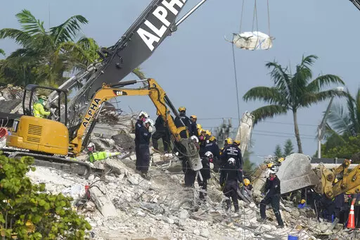 Rescue crews work at the site of the collapsed Champlain Towers South condo building after the remaining structure was demolished Sunday, in Surfside, Fla., Monday, July 5, 2021. Attorneys for the families who lost relatives or homes in last year’s collapse of a Florida condominium tower that killed 98 people finalized a $1 billion settlement on Friday, May 27, 2022. (AP Photo/Lynne Sladky, File)