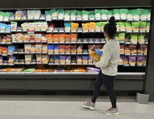 A shopper peruses cheese offerings at a Target store Wednesday, Oct. 4, 2023, in Sheridan, Colo. On Thursday, the Labor Department issues its report on inflation at the consumer level. (AP Photo/David Zalubowski)