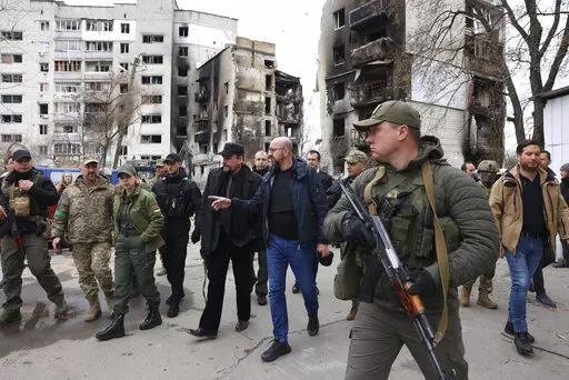 In this image provided by the European Council, European Council President Charles Michel, center, as he is given a tour of the region of Borodyanka, Ukraine, Wednesday, April 20, 2022. (Dario Pignatelli/European Council via AP)