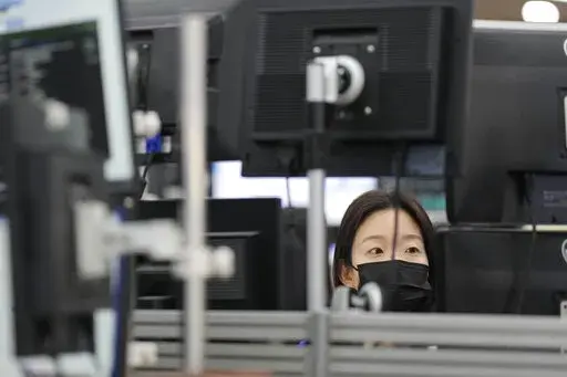 A currency trader watches computer monitors at a foreign exchange dealing room in Seoul, South Korea, Tuesday, Oct. 25, 2022. Shares advanced Tuesday in Asia after Wall Street shook off an early bout of unsettled trading and ended higher. (AP Photo/Lee Jin-man)
