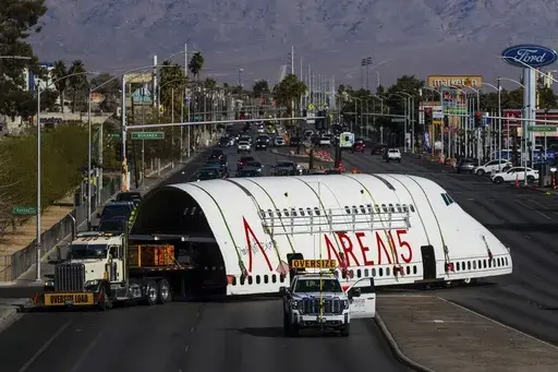 A section of a 747 airplane moves through Las Vegas streets on the way to a new home at Area 15 where it will be part of an immersive art display, on Wednesday, Feb. 26, 2025. (AP Photo/Ty ONeil)