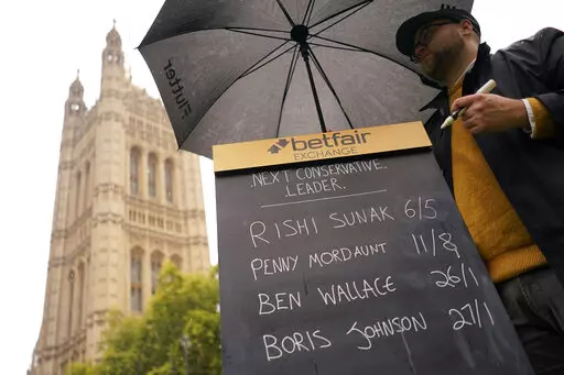 A bookmaker takes bets for the next British Prime Minister after Liz Truss resigned in London, Thursday, Oct. 20, 2022. Truss resigned Thursday, bowing to the inevitable after a tumultuous, short-lived term in which her policies triggered turmoil in financial markets and a rebellion in her party that obliterated her authority.(AP Photo/Alberto Pezzali)