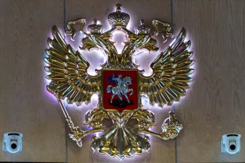 The emblem for the Russian Defense Ministry is displayed at the ministry building in Moscow, Russia on Monday, Sept. 26, 2016. On Saturday, Oct. 15, 2022, the ministry said two men fired at troops at a Russian military firing range near Ukraine, killing 11 and wounding 15 others, before getting killed. (AP Photo/Ivan Sekretarev, File)