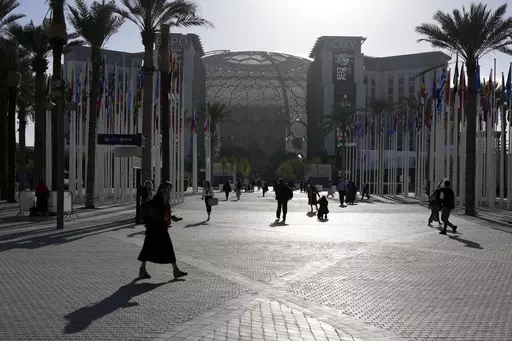 People walk through the venue at the COP28 U.N. Climate Summit near the Al Wasl Dome at Expo City, Thursday, Nov. 30, 2023, in Dubai, United Arab Emirates. (AP Photo/Rafiq Maqbool, File)