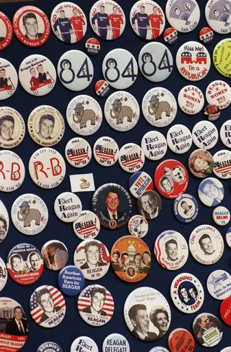 This photo shows buttons from the 1984 Reagan-Bush campaign. Reagan announced on Jan. 29, 1984. His approval rating was 52% that month. Despite concerns about his age — he was 73 and the oldest president in history at the time — Reagan handily defeated Walter Mondale, a Democrat. (AP Photo, File)