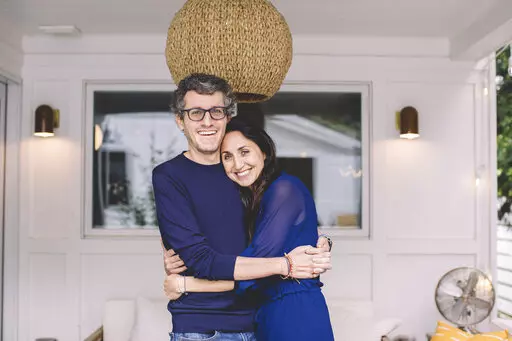 This photo provided by ALS patient Brian Wallach shows him and his wife, Sandra Abrevaya, at their home in Chicago on May 2021. Wallach, who formed I AM ALS with Abrevaya after being diagnosed with ALS in 2017, spent years working on legislation with congressional staffers, researchers and patients which passed the House last December in a landslide 423-3 vote. (Julie Dietz via AP)