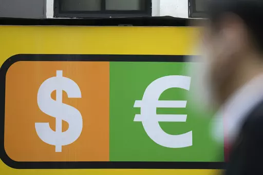 A man walks near a sign of foreign currency outside a money exchange office at a shopping district in Seoul, South Korea, Thursday, April 6, 2023. Asian shares were trading mostly lower Thursday as investors turned their attention to upcoming earnings reports and other economic indicators.(AP Photo/Lee Jin-man)