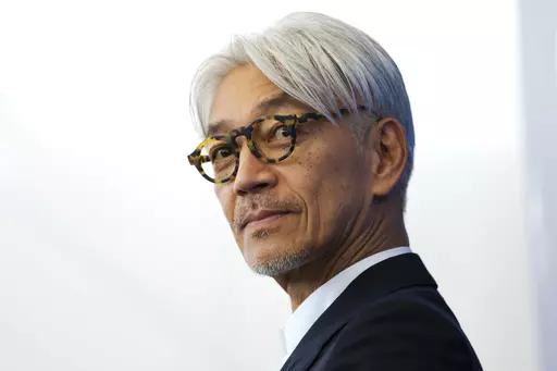 Maestro Ryuichi Sakamoto poses during a photo call for the film "Coda" at the 74th Venice Film Festival in Venice, Italy, Sept. 3, 2017. Japan's recording company Avex says Sakamoto, a musician who scored for Hollywood movies such as “The Last Emperor” and “The Revenant,” has died. He was 71. He died March 28, according to the statement released Sunday, April 2, 2023. (AP Photo/Domenico Stinellis, File)