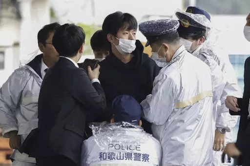 A man who was later identified as Ryuji Kimura is arrested after what appeared to be a pipe bomb was thrown at Japanese Prime Minister Fumio Kishida during his visit at a port in Wakayama, western Japan, on April 15, 2023. Prosecutors in Japan indicted the 24-year-old man Wednesday, Sept. 6, 2023 on attempted murder and other charges in the explosive attack on Prime Minister Fumio Kishida in April, Japanese media reported. (Kyodo News via AP, File)