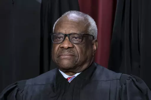 Associate Justice Clarence Thomas joins other members of the Supreme Court as they pose for a new group portrait, at the Supreme Court building in Washington, Oct. 7, 2022. Thomas has for more than two decades accepted luxury trips nearly every year from Republican megadonor Harlan Crow without reporting them on financial disclosure forms, ProPublica reports. (AP Photo/J. Scott Applewhite, File)