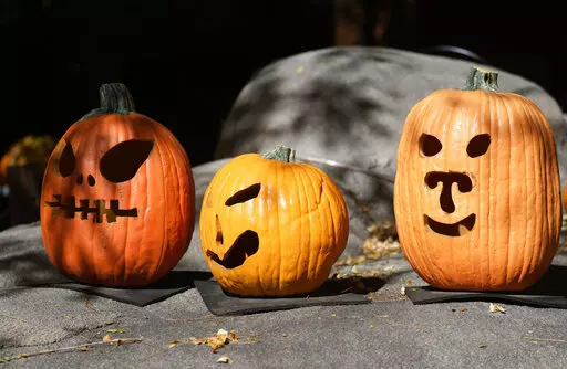 A display of pumpkins prepared for Halloween welcomes visitors at the Denver Zoo Tuesday, Oct. 18, 2022, in Denver. Forecasters predict that the warm weather will remain in place over the intermountain West through the week ahead. (AP Photo/David Zalubowski)