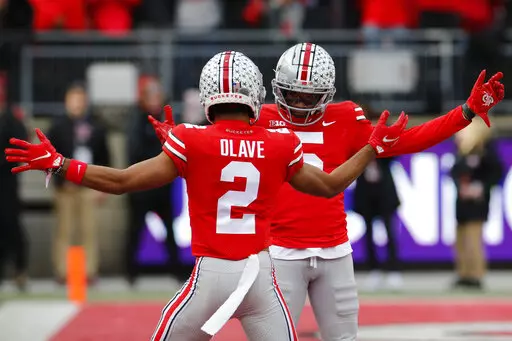Ohio State receiver Garrett Wilson, right, celebrates his touchdown against Michigan State with teammate Chris Olave during the first half of an NCAA college football game Saturday, Nov. 20, 2021, in Columbus, Ohio. (AP Photo/Jay LaPrete)