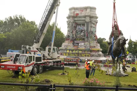Crews remove one of the country's largest remaining monuments to the Confederacy, a towering statue of Confederate General Robert E. Lee on Monument Avenue in Richmond, Va., Wednesday, Sept. 8, 2021. (AP Photo/Steve Helber)