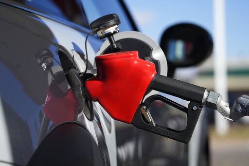 A motorist fuels a vehicle at an Exxon station Oct. 27, 2021, in Littleton, Colo. President Joe Biden is warning Americans already exhausted by inflation at a 40-year high that gas prices could get higher if Russian President Vladimir Putin chooses to invade Ukraine. (AP Photo/David Zalubowski, File)