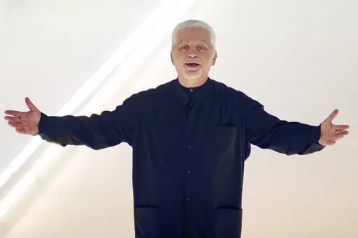 Franco-Spanish fashion designer Paco Rabanne acknowledges the applause at the end of his fall-winter 2000/2001 collection on March 3, 2000 in Paris, France. The Spanish-born pace-setting designer known for perfumes sold worldwide and his metallic, space-age fashions, has died, the group that owns his fashion house announced on its website Friday Feb.3, 2023. He was 88. (AP Photo/Remy de la Mauviniere, File)