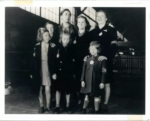 In this May 26, 1946, photo, Ginger Lane, bottom right, and her siblings arrive in New York City as Holocaust survivors who were hidden in a fruit orchard near Berlin by non-Jews. Their mother was killed at the death camp at Auschwitz. Lane has since made it her lifelong mission to educate others of this painful past. (Courtesy Ginger Lane via AP)