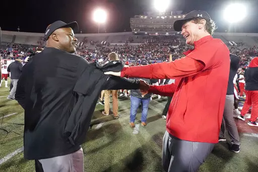 Texas Tech interim head coach Sonny Cumbie, right, celebrates with associate head coach Derek Jones after Texas Tech beat Mississippi State 34-7 in the Liberty Bowl NCAA college football game Tuesday, Dec. 28, 2021, in Memphis, Tenn. (AP Photo/Mark Humphrey)