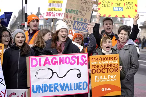 Junior doctors hold placards as they stand at a picket line outside St Thomas' Hospital in Westminster in London, Monday, March 13, 2023. Thousands of junior hospital doctors are due to walk out for three days starting Monday. It follows strikes in recent months by nurses and ambulance staff. The NHS said it would prioritize emergency care during the strike but thousands of appointments will be canceled. (AP Photo/Kirsty Wigglesworth)