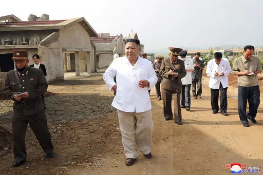 In this undated photo provided on July 23, 2020 by the North Korean government, North Korean leader Kim Jong Un, center, visits a new chicken farm being built in Hwangju County, North Korea. Independent journalists were not given access to cover the event depicted in this image distributed by the North Korean government. The content of this image is as provided and cannot be independently verified. Korean language watermark on image as provided by source reads: "KCNA" which is the abbreviation f