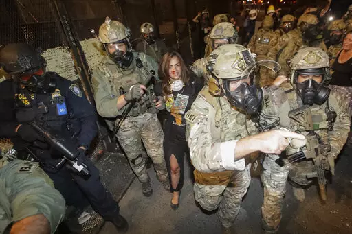 A bloodied demonstrator is arrested by federal police during a Black Lives Matter protest on July 27, 2020, in Portland, Ore. U.S. Department of Homeland Security officials under then-President Donald Trump sought to compile intelligence dossiers on everyone attending Black Lives Matter protests, according to a newly unredacted report. Sen. Ron Wyden, D-Oregon, who obtained the report, said in an email to reporters that surveillance of Portland protesters in 2020 "included lists of friends, fami
