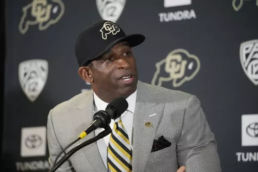 Deion Sanders speaks after being introduced as the new head football coach at the University of Colorado during a news conference Sunday, Dec. 4, 2022, in Boulder, Colo. The spring transfer window for college football players closed with 43 scholarship players -- the equivalent of half a roster -- from coach Deion Sanders' Colorado program having entered the portal since the spring game was played on April 15. (AP Photo/David Zalubowski, File)